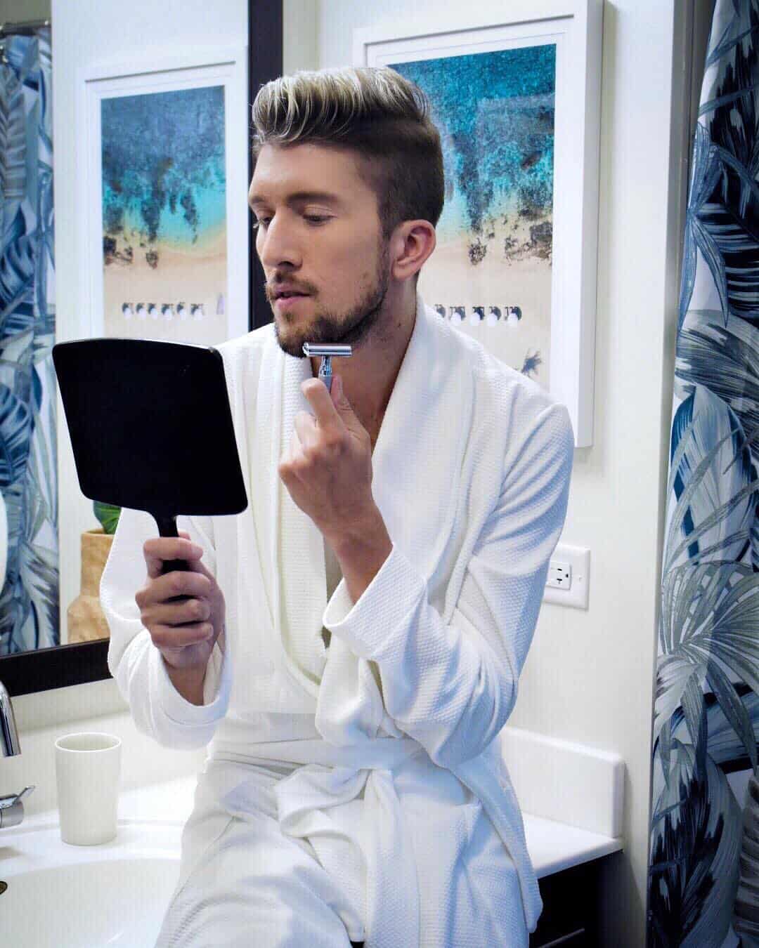man in robe using a rockwell razor for shaving beard