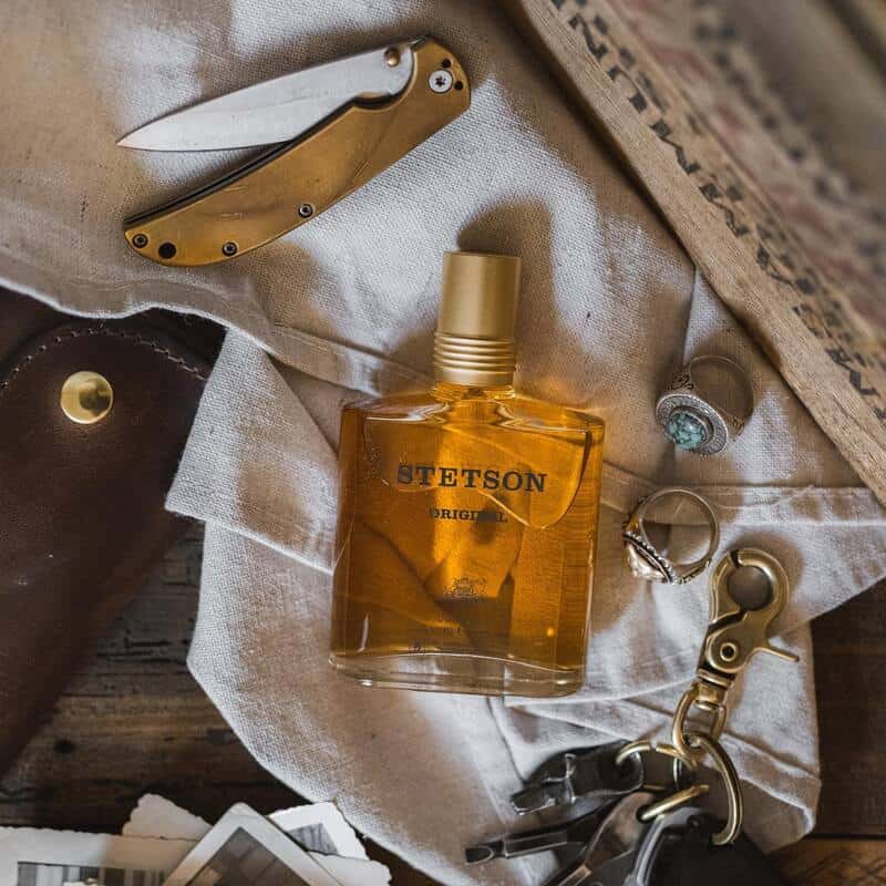 a bottle of Stetson Original cologne and rings, pocket knife and a set of keys