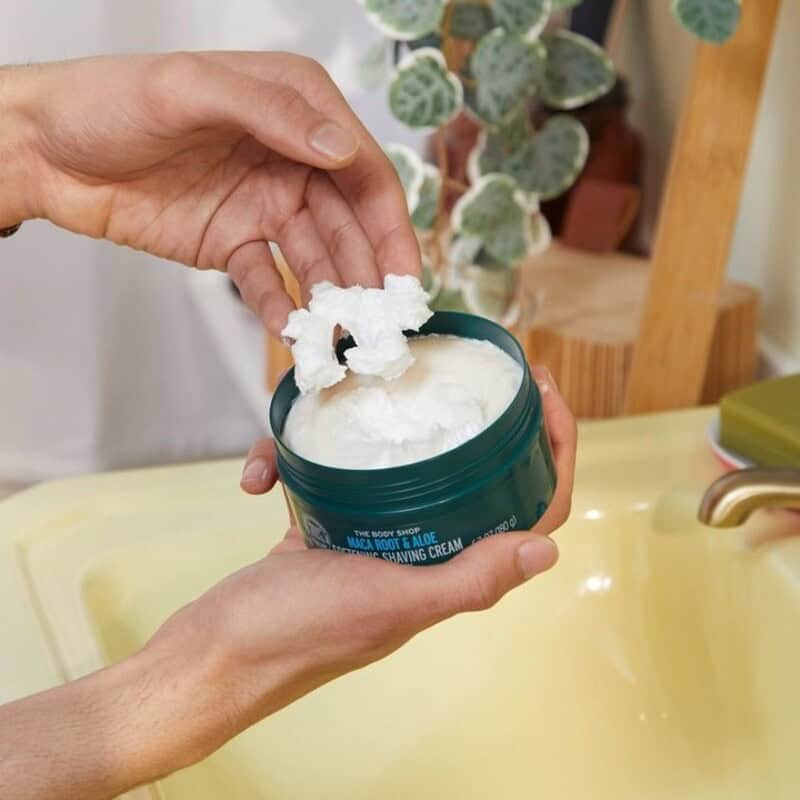 man scraping a Maca Root and Aloe Shaving Cream by The Body Shop