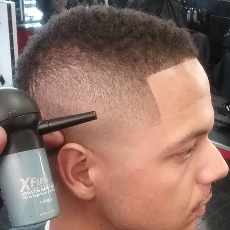 barber using the Xfusion Keratin Hair Fiber by Toppik