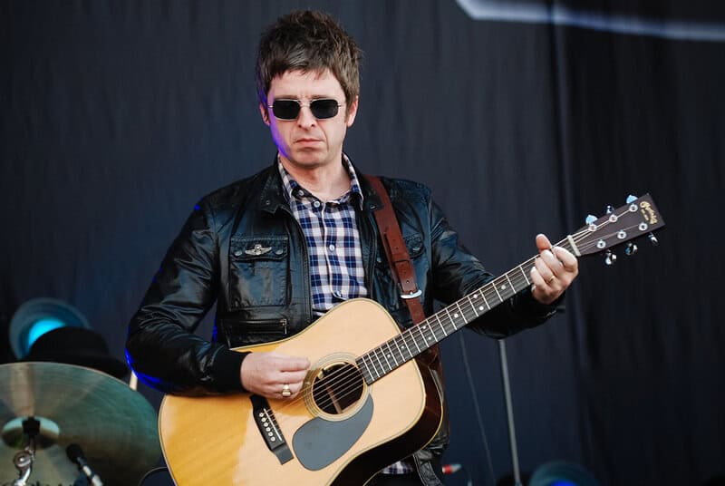 Noel Gallagher Playing a guitar