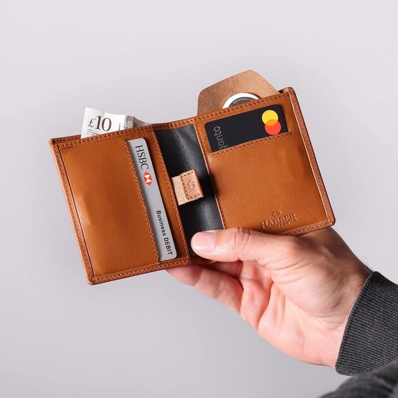 man holding a leather bifold wallet with RFID protection by Harber London
