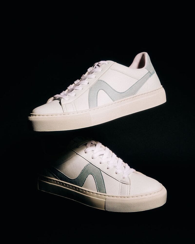 a pair of KOIO vegan 01 sneakers emerging from the shadow