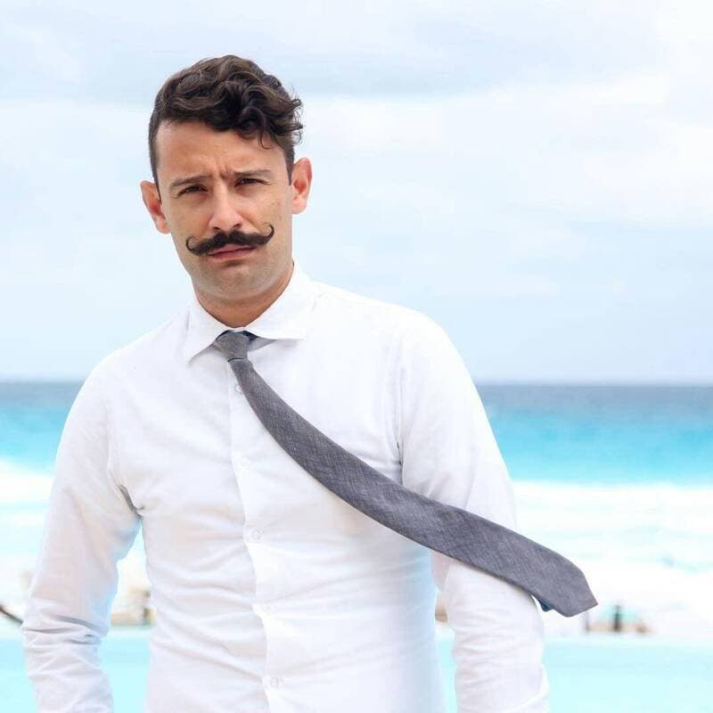 man with handlebar mustache style wearing a shirt and tie