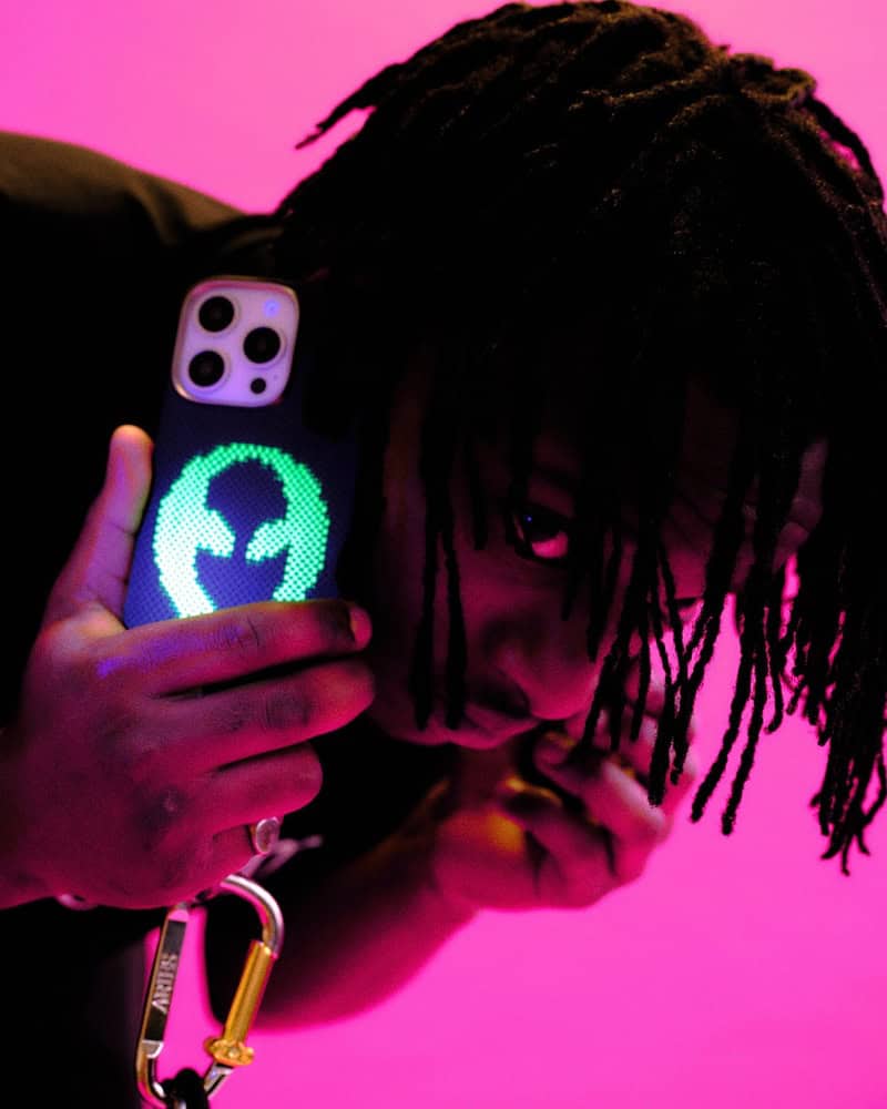 man holding a phone with the Alien Luminous Case