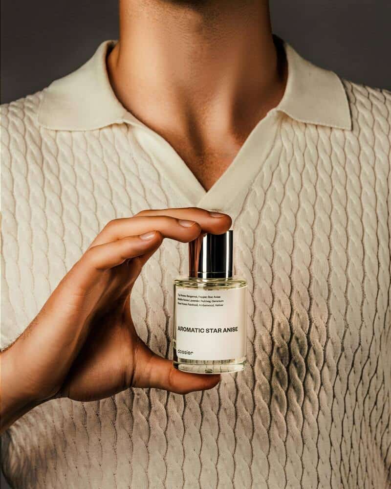 man holding a bottle of Aromatic Star Anise perfume by Dossier