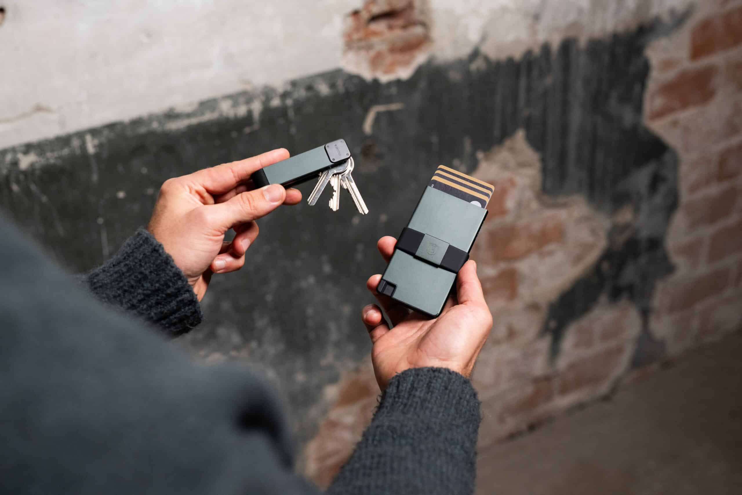 a person holding a key box and a key holder