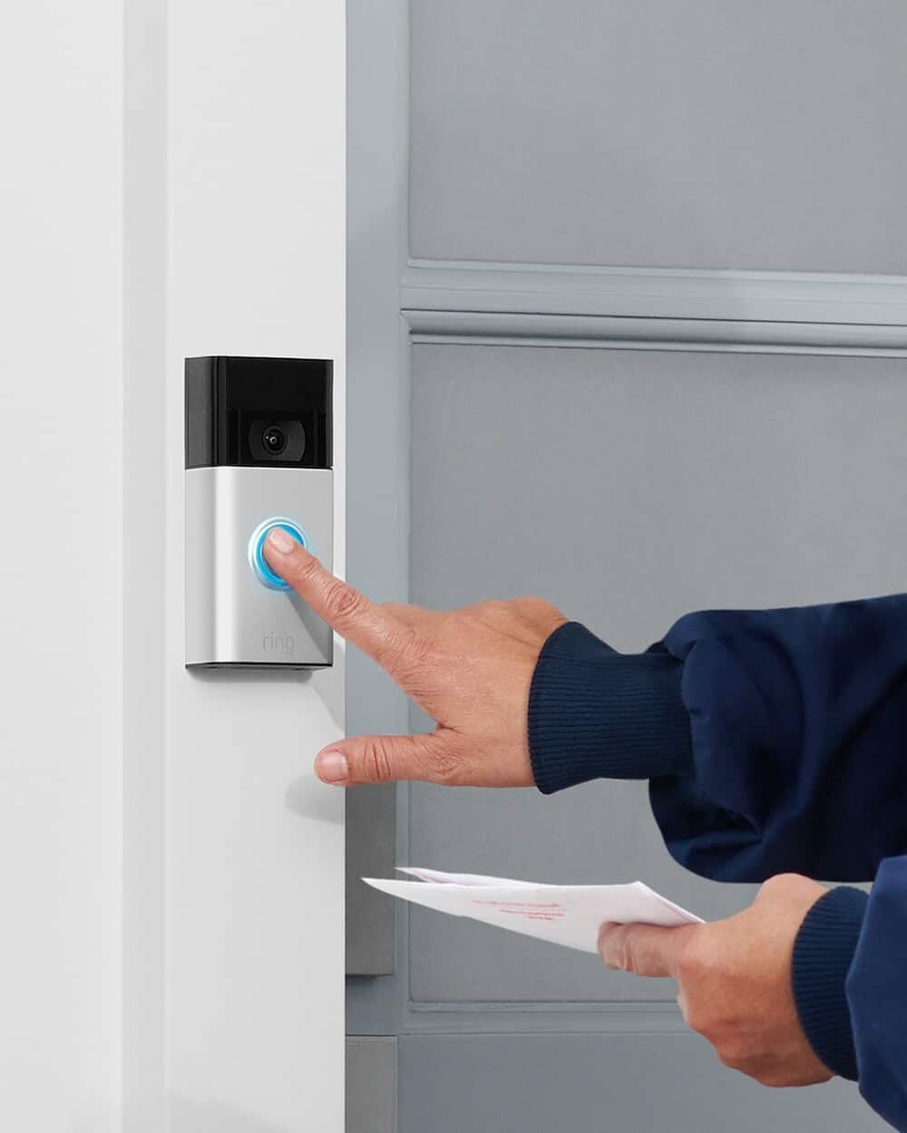 person pressing the button of a Ring Doorbell