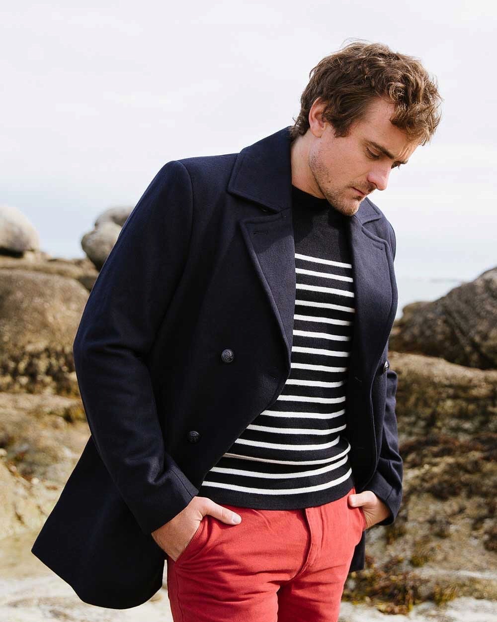 man in a navy double breasted pea coat by Nautica