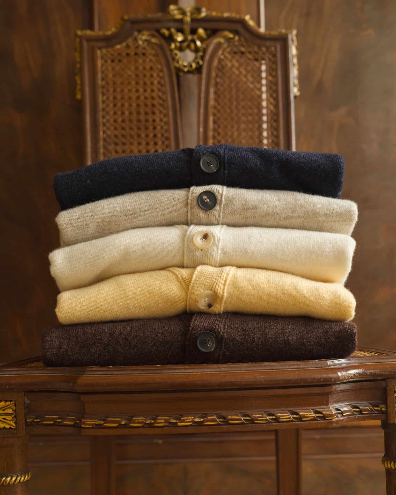 a pile of lambswool cardigans by besnard