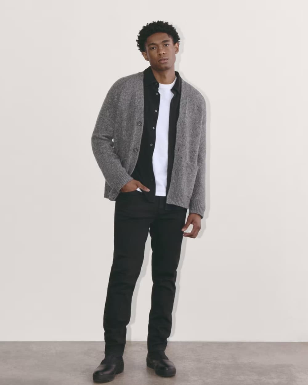 man in a black shirt and black jeans