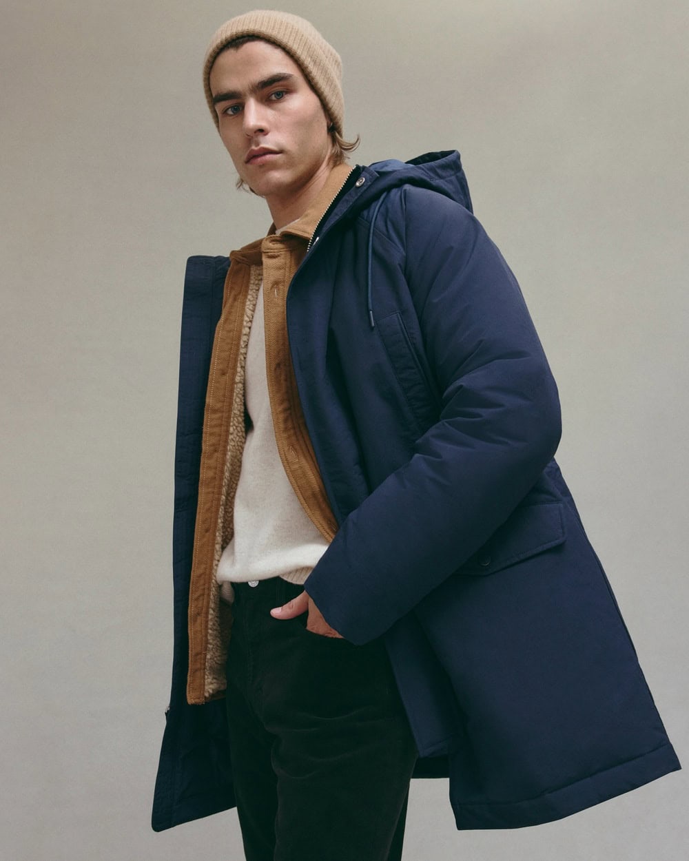 man in a brown beanie and navy coat