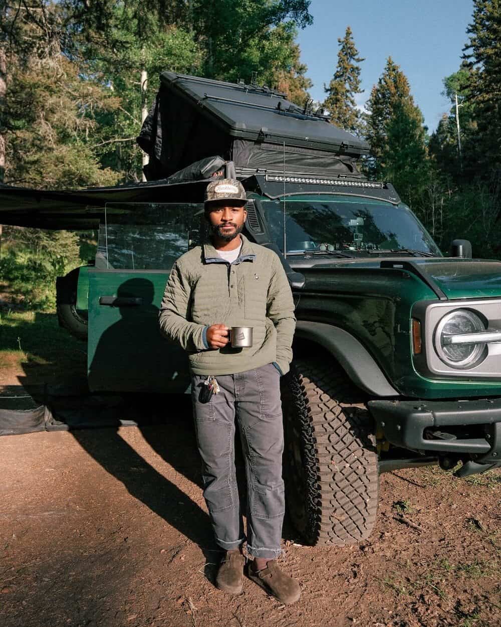 man camping holding a cup