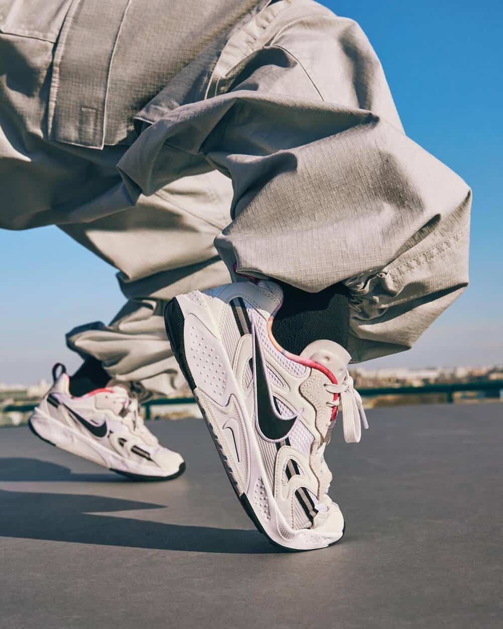 man holding a pair of nike Jam sneakers