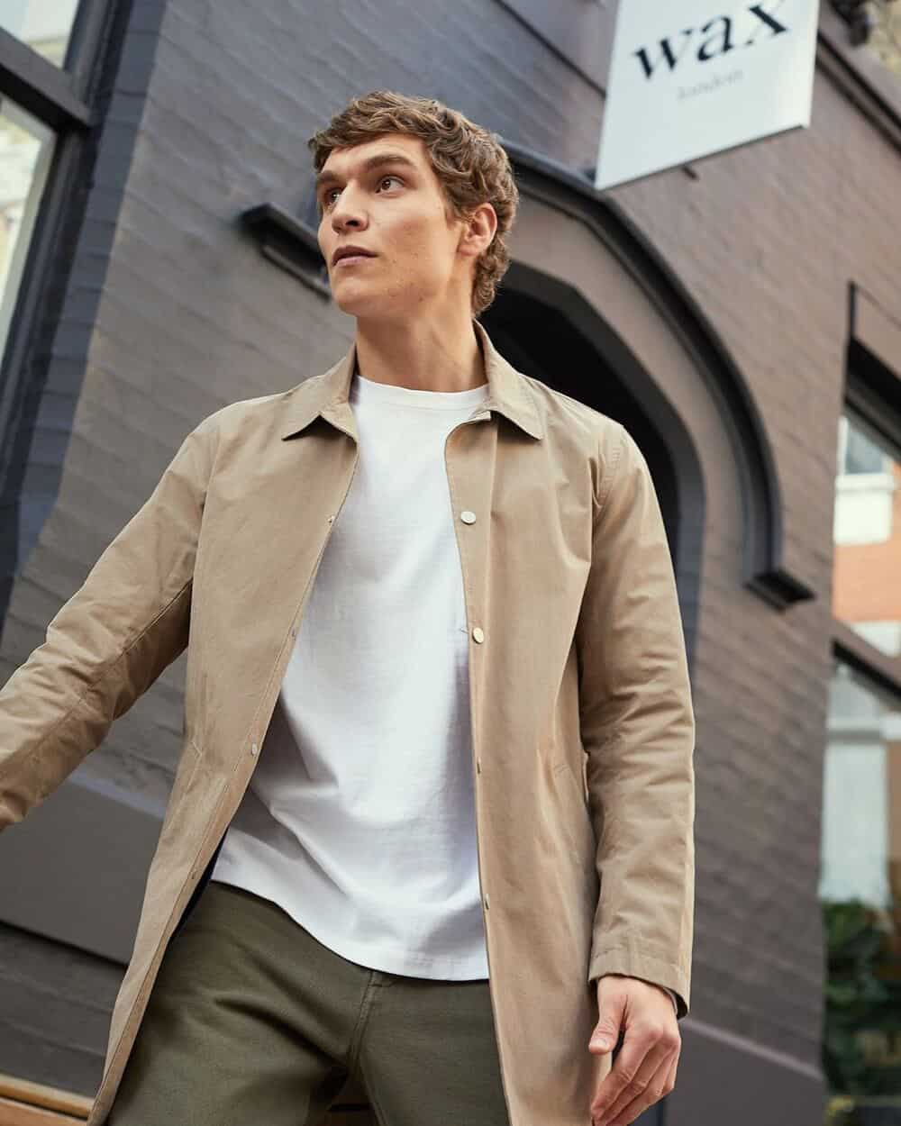 man wearing a white t-shirt under a coat