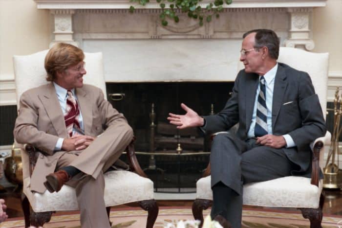 President George H.W. Bush visits with Robert Redford in the Oval Office 27 July 1989