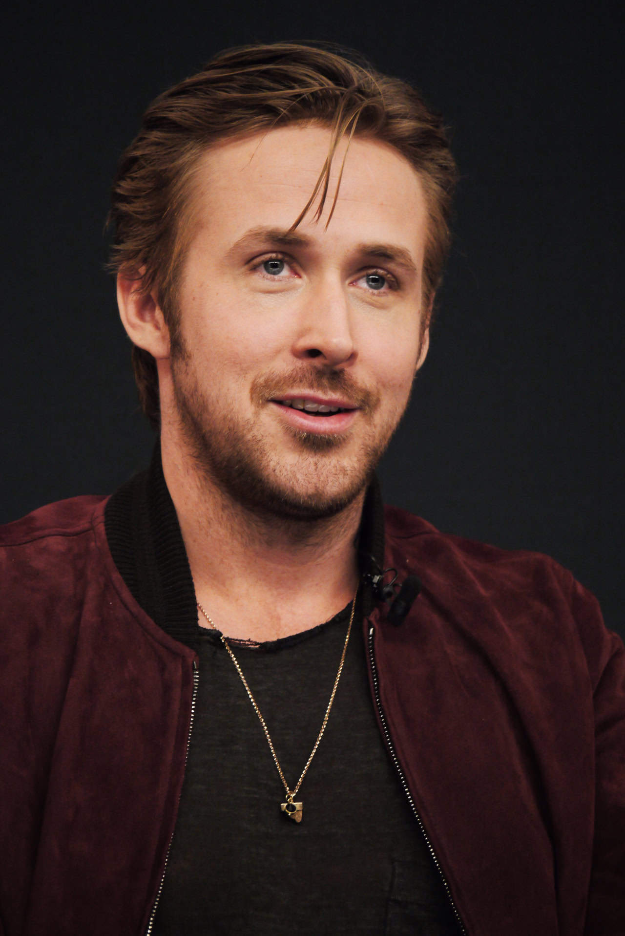 Ryan Gosling in a burgundy bomber jacket
