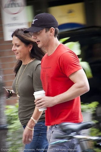 Shia LaBeouf wearing a black hat and red t-shirt