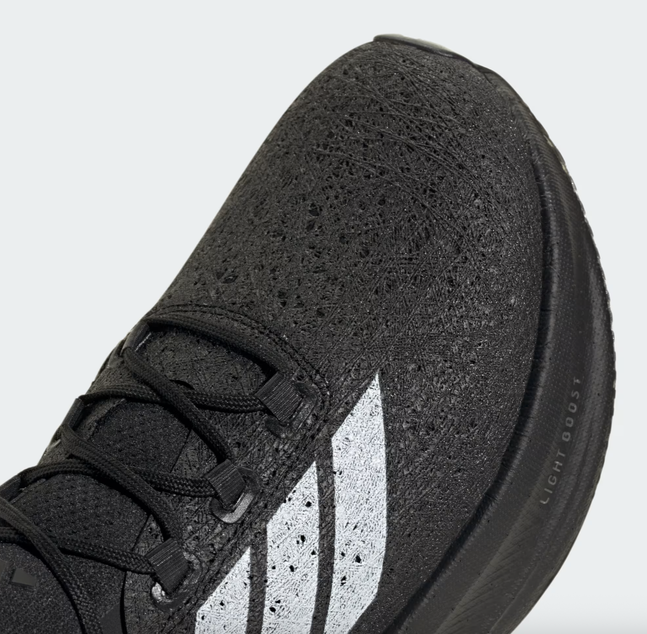 High-performance black running shoe with waterproof upper, lightweight boost midsole, and enhanced grip outsole for running and athletic activities. Perfect for sports and fitness enthusiasts.