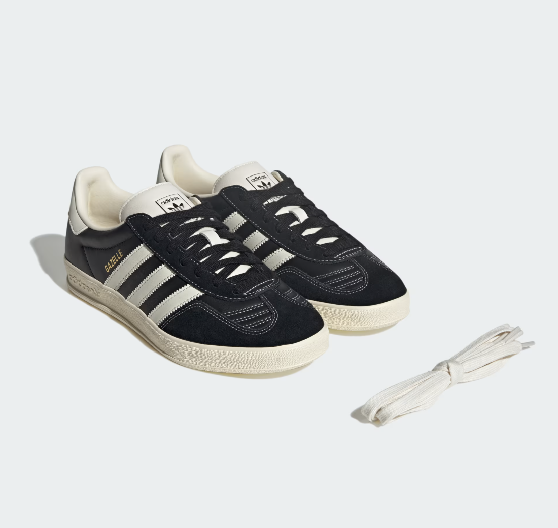 Adidas Gazelle sneakers in black and cream with iconic three-stripe design, perfect for casual men's streetwear style. Comes with extra laces for customizable look.
